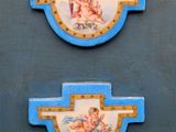 two blue and white wall plaques with angels on them