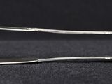 a pair of tonges sitting on top of a black surface