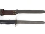 two knives with leather sheaths on them on a white surface