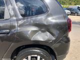 a car that has been damaged and is parked on the side of the road