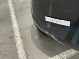 a sticker on the back of a car that is parked in a parking lot