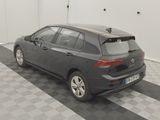 a black car parked in a garage with a checkered floor