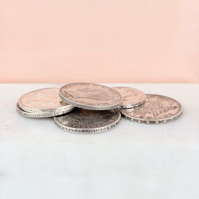 a close up of a pile of coins sitting on top of a table