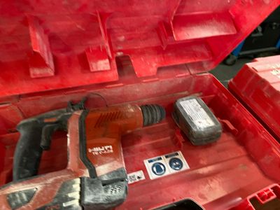 a red tool box with a hammer and other tools in it