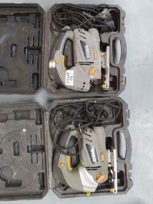 two electric tools are in a case on a table