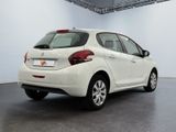 the rear end of a white nissan versa parked in a garage