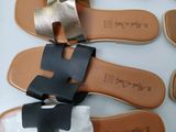 several different types of sandals are lined up on a table