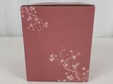 the small pink box is sitting on a white surface