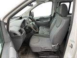 the interior of a white van with the front seats folded down