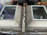 two ovens that are sitting on a table