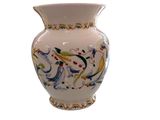 a white vase with a floral design on it