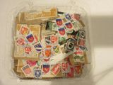 a plastic container filled with stamps and a pair of scissors