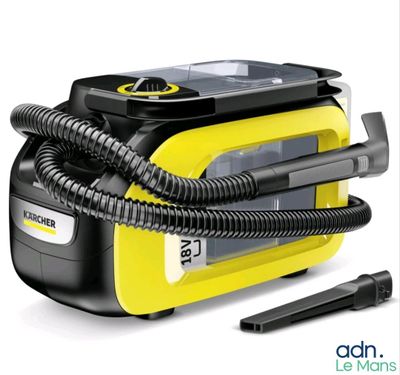 the yellow and black steam cleanerer is next to a black and gray hose