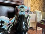 two vases sitting on a table in front of a piano
