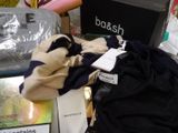a pile of clothing and a bag on a table