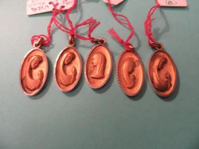 six bronze medal medals with red ribbons hang on a blue surface
