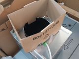 a cardboard box with a black cat inside of it