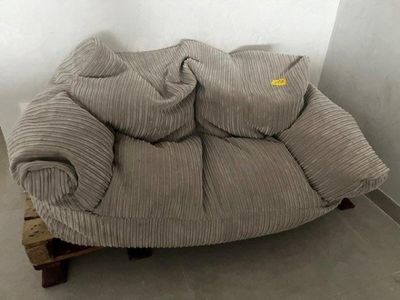 a couch that has a lot of pillows on top of it
