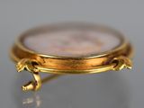 an image of a close up of a gold watch on a table