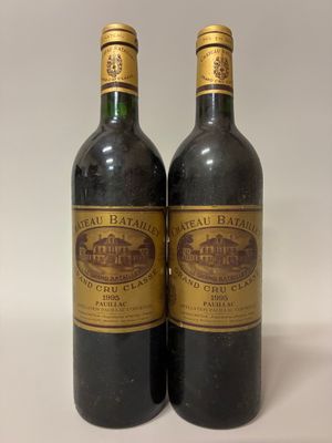 two bottles of wine sitting next to each other on a table