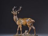 a bronze statue of a deer and a baby deer