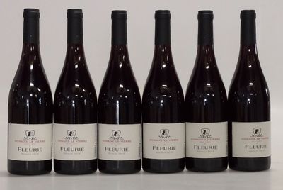 six bottles of wine are lined up in a row on a table