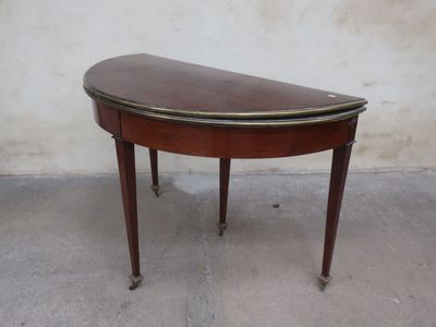 a small wooden table with a curved top on it