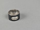 a close up of a ring on a table with a white background