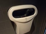 a urinal in the corner of a bathroom stall