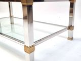 an image of a glass and brass coffee table