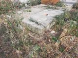 a concrete block sitting in the middle of a field