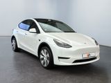 a white tesla model x parked in a large room
