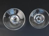 three empty wine glasses sitting on top of a black table