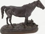 statue of a horse standing on a rock on a white background