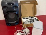 two speakers and a speaker box on a red table
