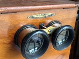 a wooden box with two binoculars on top of it