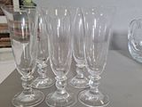 several empty wine glasses are lined up on a table