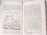 an open book with a drawing on it on a table