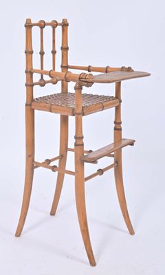 a wooden high chair with a tray on top of it