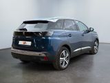 the rear view of a blue car parked in a room