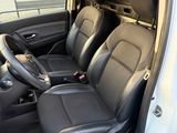the interior of a white van with black leather seats and a steering wheel