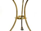 a gold metal table with a glass top on a white background
