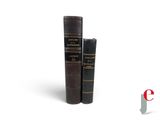 two books sitting on top of each other on a white surface
