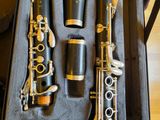 two clarinets in a case sitting on the floor