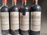 four bottles of wine are lined up on a table