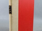 an image of a book with a red cover sitting on top of a table