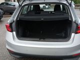 cars are parked in a parking lot with the back of the car open