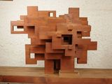 a sculpture made of wood blocks sitting on a table