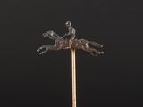 a close up of a statue of a man riding a horse on a stick