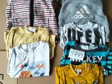 a lot of clothes that are on a cardboard box